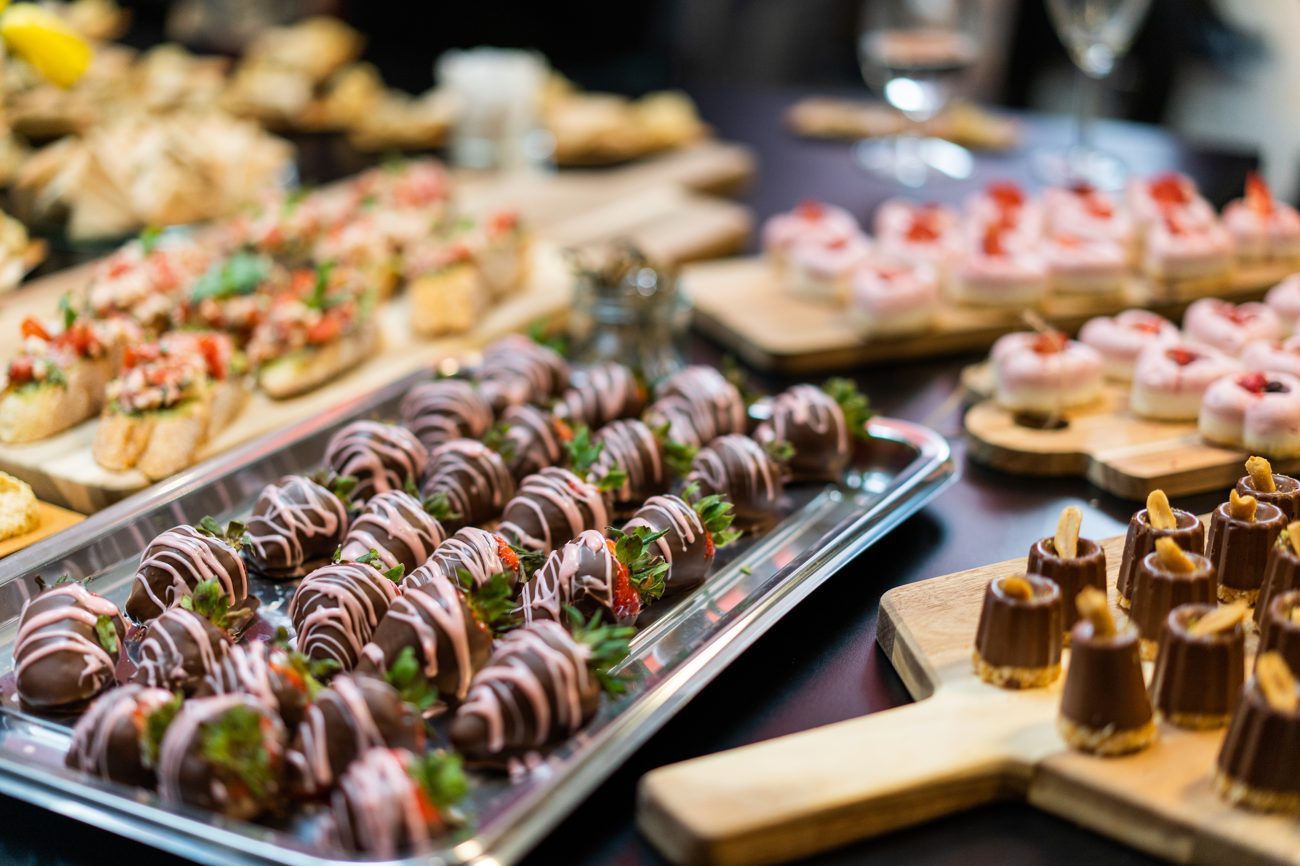 Chocolate-dipped strawberries and treats on a platter
