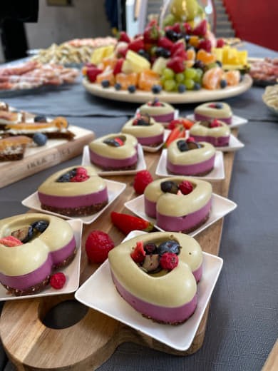 Raw mini-cakes plated on a buffet table