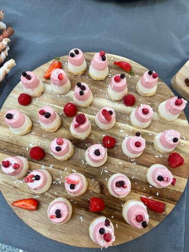 A board of raw mini-cakes with berries